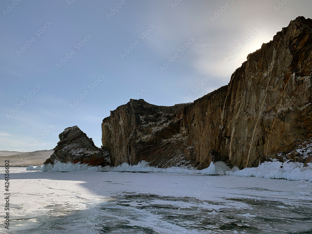 A beautiful winter landscape with majestic ice-covered rocks, mountains and hills.