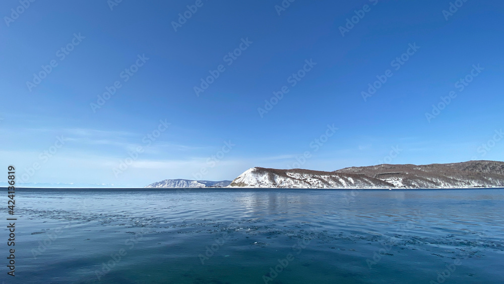 The non-freezing Angara river near Lake Baikal. Northern landscape of frozen Lake Baikal.