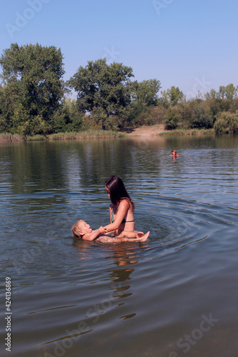 child and mother in the water