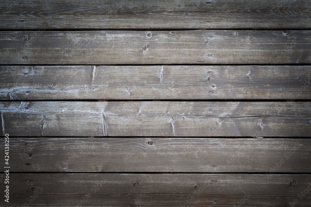 Obraz premium Natural weathered wooden boards background. Dark grey textured horizontal wood planks with nails. Copy space, vignette.