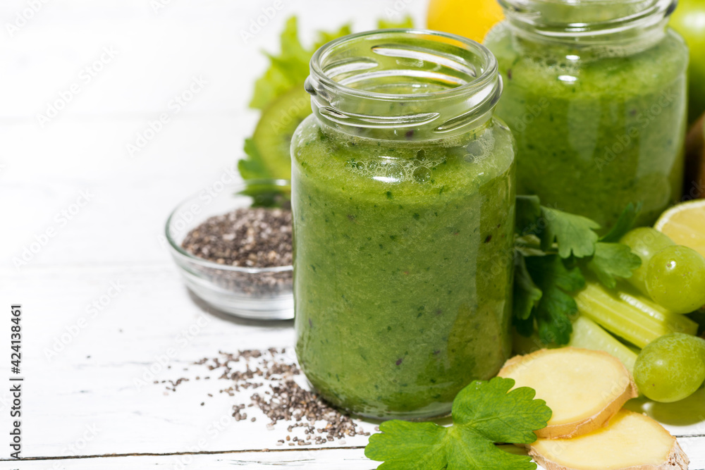healthy green fruit and vegetable smoothies in jars on white table healthy green fruit and vegetable smoothies in jars on white table