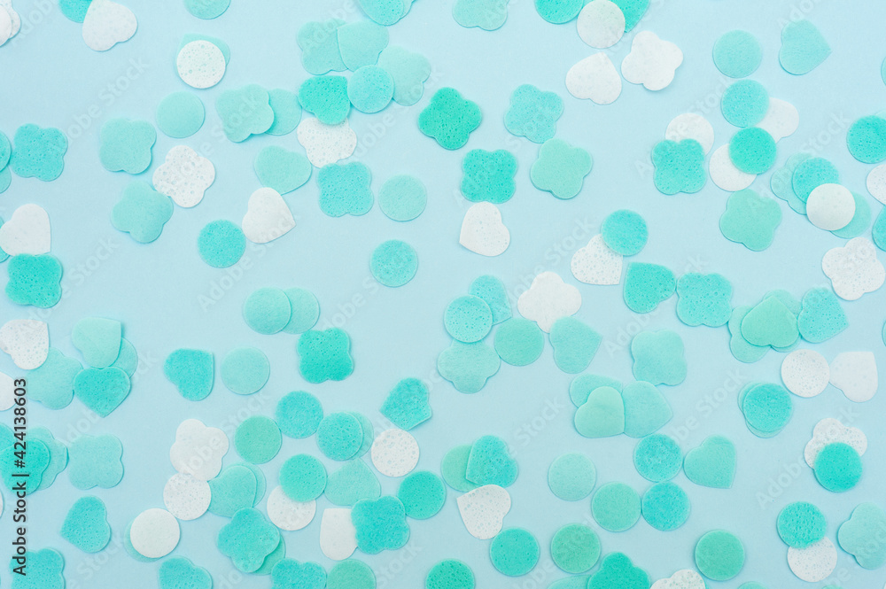 Abstract background of blue color. Pieces of soap of different shapes on a blue background 