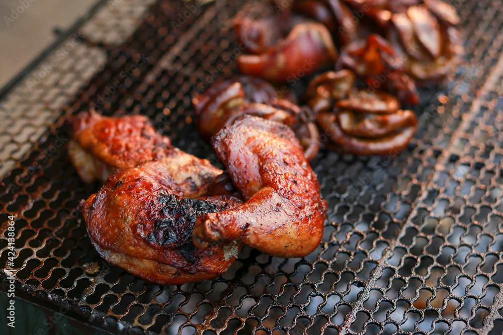 Grilled chicken thighs up close on a charcoal stove for sale on the roadside in Thailand. But some are burnt black, grilled food is not good for health. But I'm hungry Grilled chicken thighs up close on a charcoal stove for sale on the roadside in Thailand. But some are burnt black, grilled food is not good for health. But I'm hungry