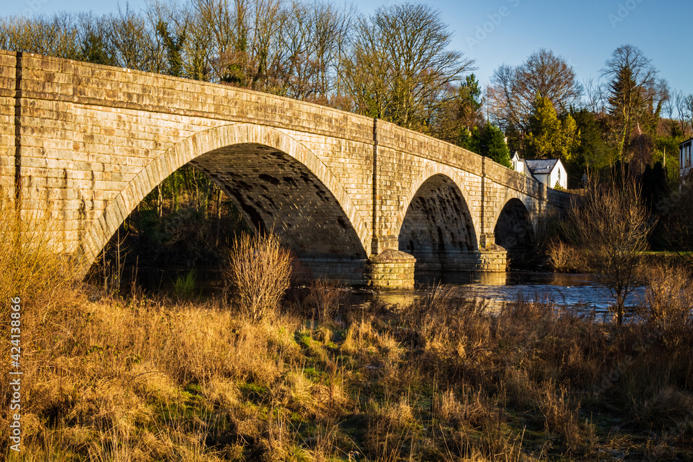 The arched Ken Bridge over the Water of Ken on a sunny winters day, Scotland