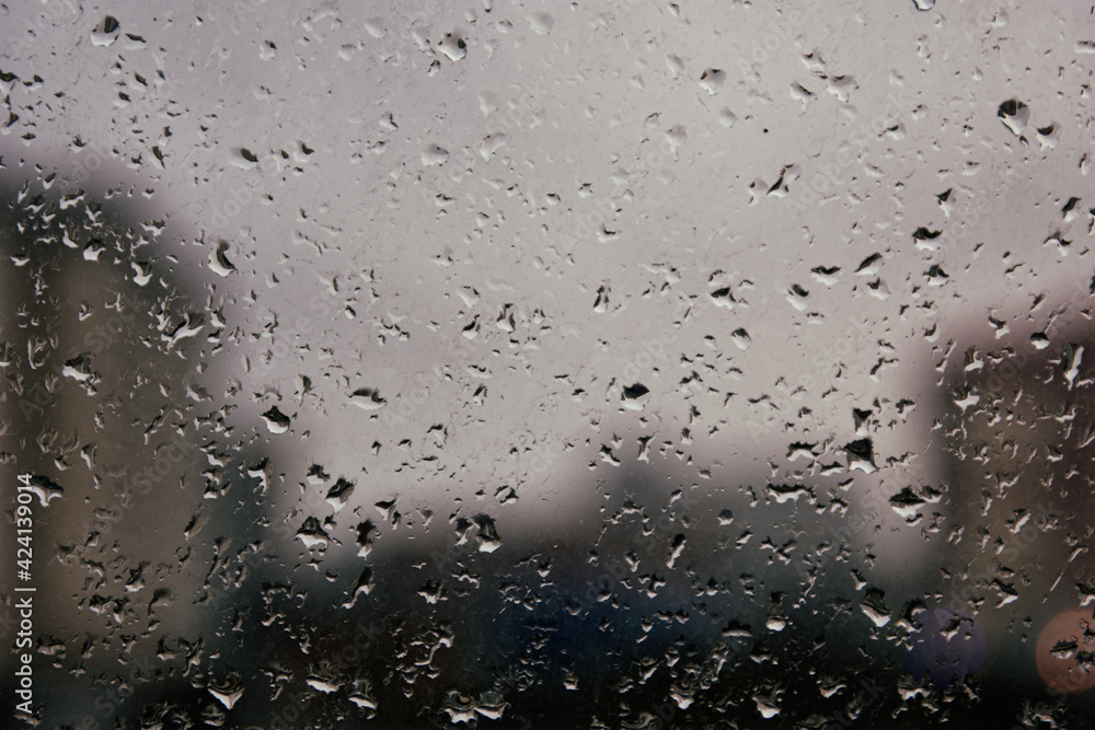 Raindrops on the window. Rainy weather. Cloudy season. Background and texture. Raindrops on the window. Rainy weather. Cloudy season. Background and texture.
