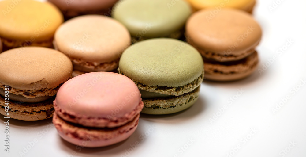 several multi-colored macaroon cakes on a white background several multi-colored macaroon cakes on a white background