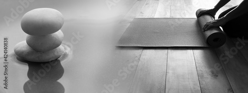 woman with yoga mat and white rock on water in zen style wellness health banner background photo