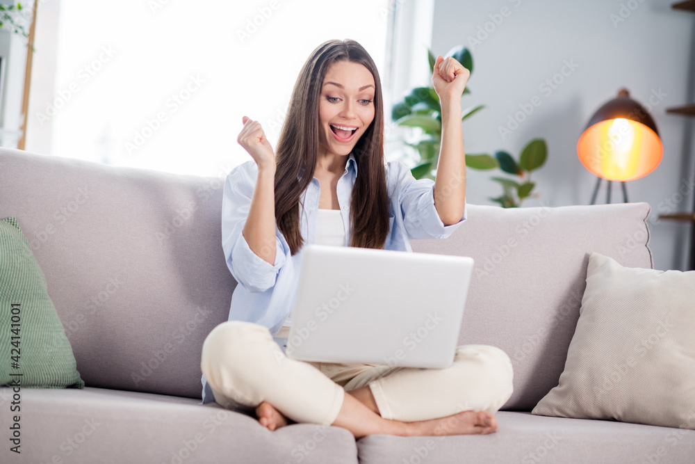 Full size photo of nice hooray brunette long hairdo lady sit talk laptop on coach wear blue shirt at home Full size photo of nice hooray brunette long hairdo lady sit talk laptop on coach wear blue shirt at home