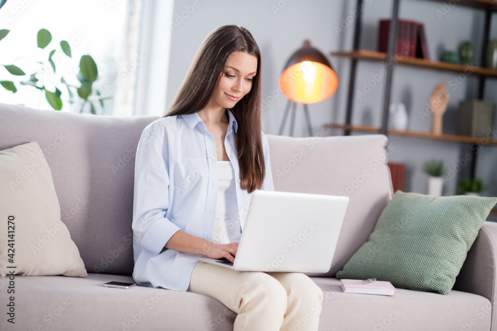 Naklejka premium Full size photo of nice optimistic brunette long hairdo lady sit with laptop wear shirt at home