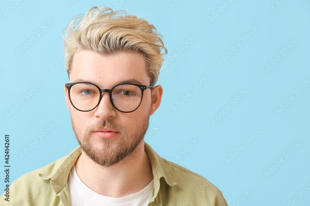 Young man wearing eyeglasses on color background Young man wearing eyeglasses on color background