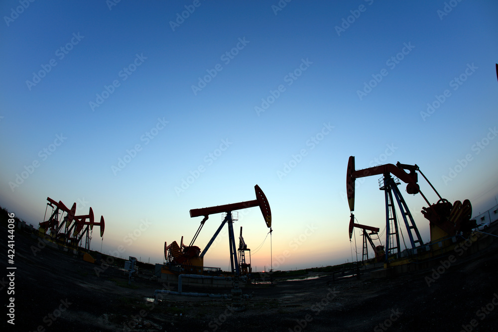 Naklejka premium in the evening, oil pumps are running