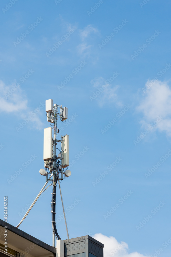 5g and 4g antenna on the roof of a residential building, Milan, Italy. Blue sky on the background