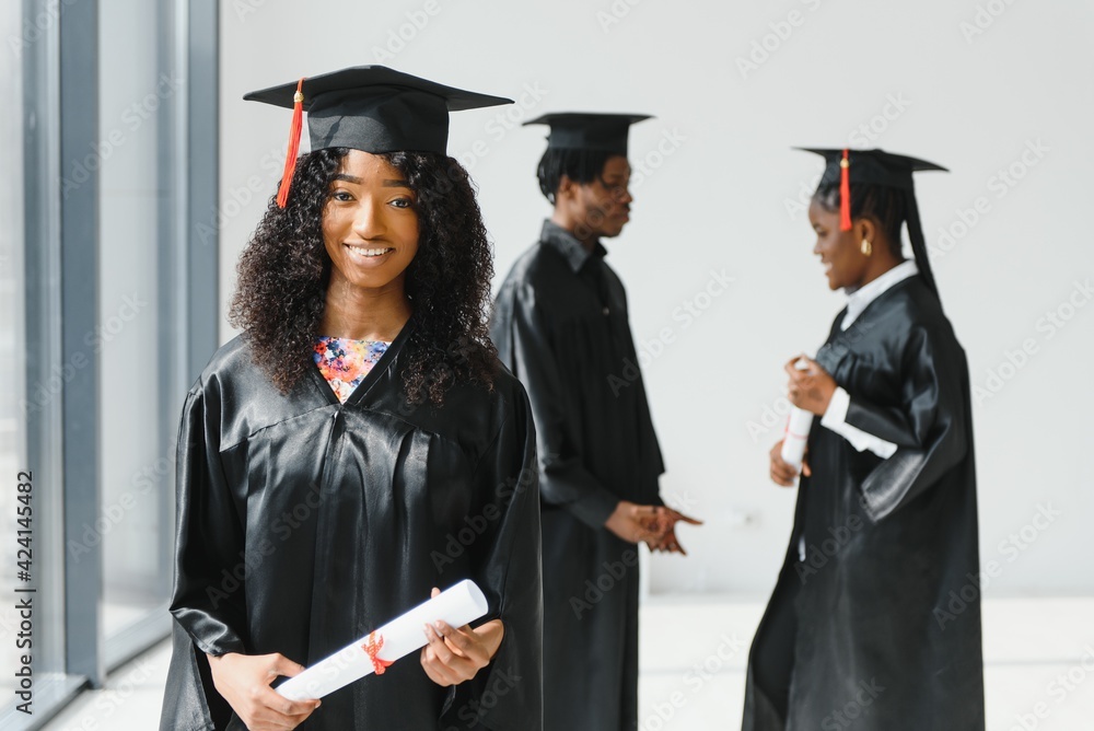 optimistic young university graduates at graduation optimistic young university graduates at graduation