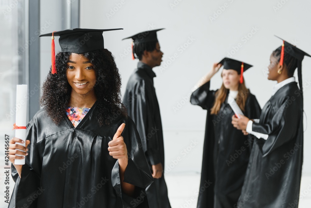 optimistic young university graduates at graduation optimistic young university graduates at graduation