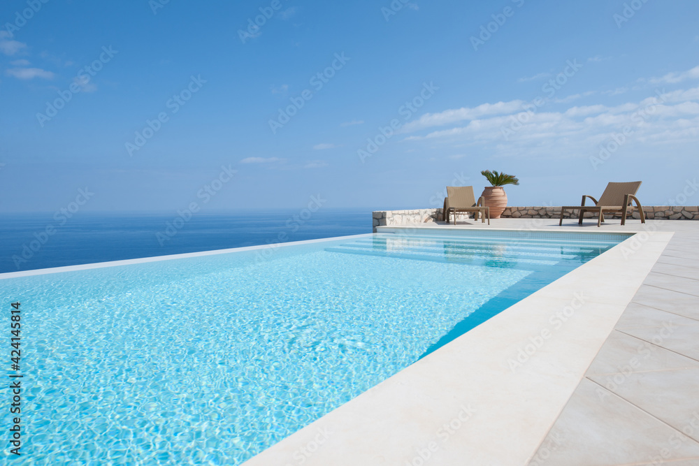 Luxury house with infinity pool over the ocean. - obrazy, fototapety, plakaty 