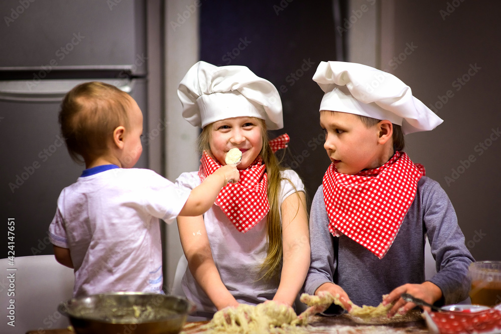 happy family fun kids baking cookies in the kitchen in chef caps selective focus happy family fun kids baking cookies in the kitchen in chef caps selective focus