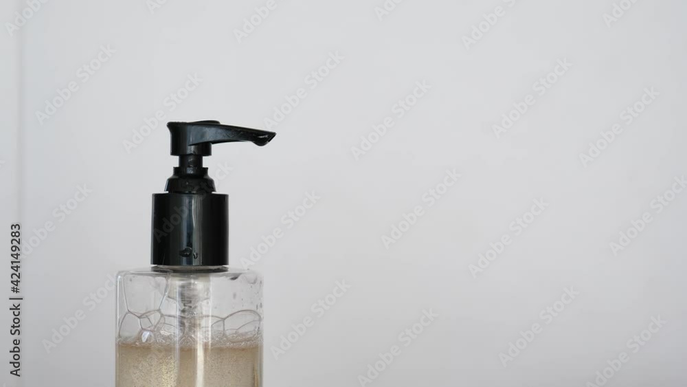 Mother help little baby to use liquid soap dispenser, closeup shot of adult and little hands. Woman press pump and soap spit out at small arm of child. Good habit of washing hands, kid learn hygiene Mother help little baby to use liquid soap dispenser, closeup shot of adult and little hands. Woman press pump and soap spit out at small arm of child. Good habit of washing hands, kid learn hygiene