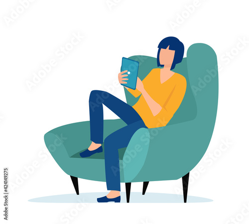 Vector of a young casual woman sitting in armchair using tablet computer