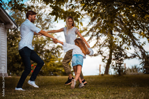 Happy family playing in backyard.