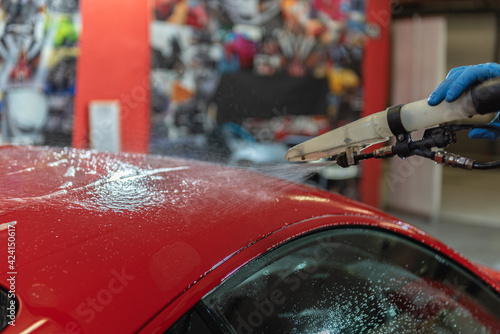 Фотография Team washing a Ferrarri 488 in an artisanal way in Andorra in 2021