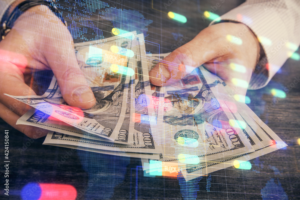 Multi exposure of technology drawing hologram and us dollars bills and man hands. Data concept Multi exposure of technology drawing hologram and us dollars bills and man hands. Data concept
