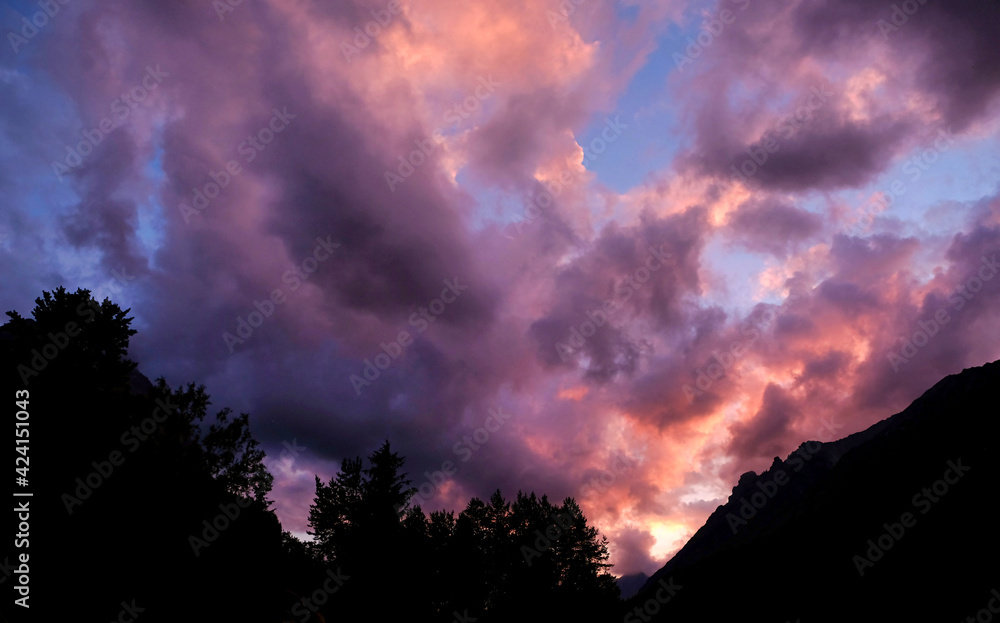 pink clouds during sunset behind the mountain pink clouds during sunset behind the mountain