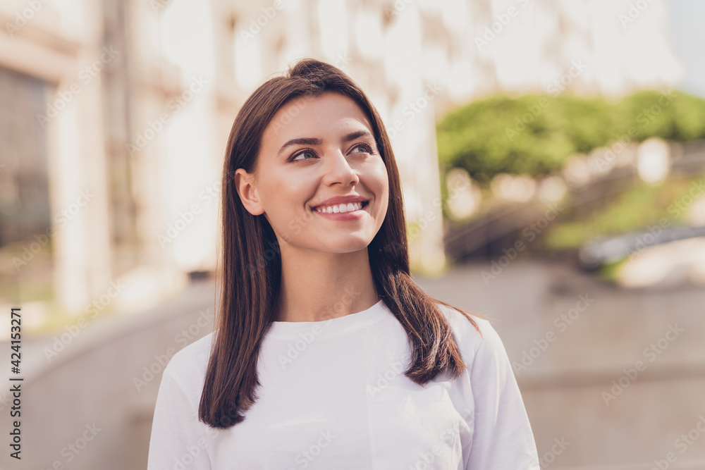Photo of optimistic brunette lady look wear white t-shirt walking in park outside