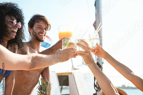 Canvas Print Happy multiracial friends cheering with tropical cocktails at boat party - Young