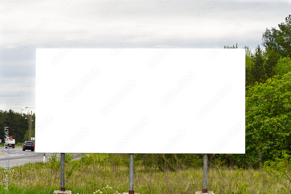 Empty white Billboard on a background of green nature. Suitable for advertising. Blank billboard and outdoor advertising. Mockup Empty white Billboard on a background of green nature. Suitable for advertising. Blank billboard and outdoor advertising. Mockup