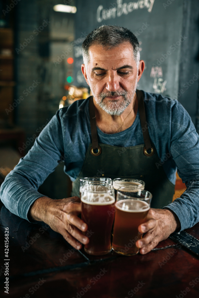 bartender serving beer in pub
