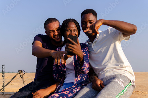 group of african student feeling excited about what they saw on their smart phone © Vic Josh
