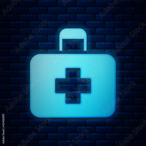 Glowing neon First aid kit icon isolated on brick wall background. Medical box with cross. Medical equipment for emergency. Healthcare concept. Vector Illustration