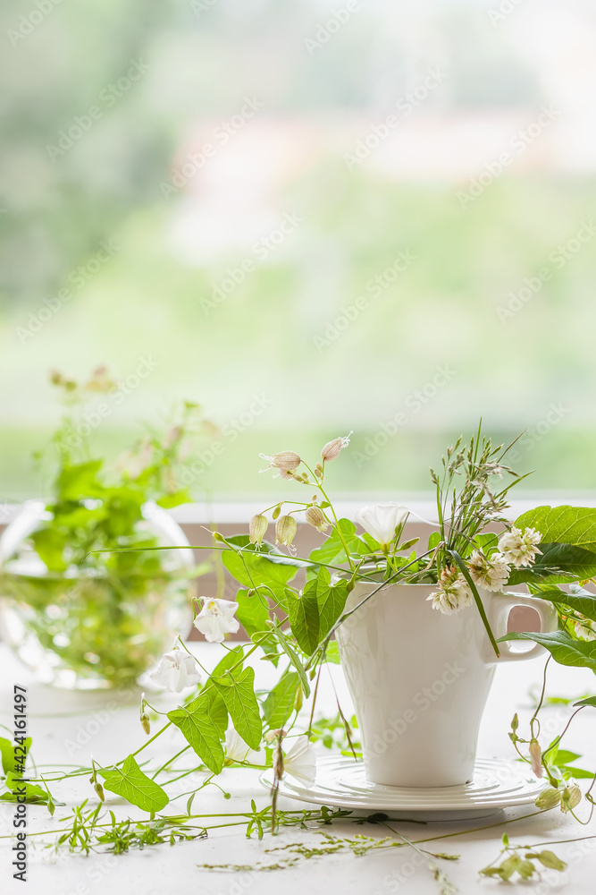 White mug with wild herbs, flowers. Romantic Wildflowers bouquet. Country life in cottage, Phytotherapy Medicinal Herbs White mug with wild herbs, flowers. Romantic Wildflowers bouquet. Country life in cottage, Phytotherapy Medicinal Herbs