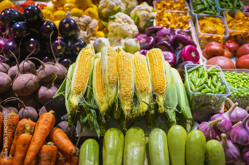 Fresh corn cobs, Farmers market, open counter of vegetables. Healthy organic food. Autumn harvest photo