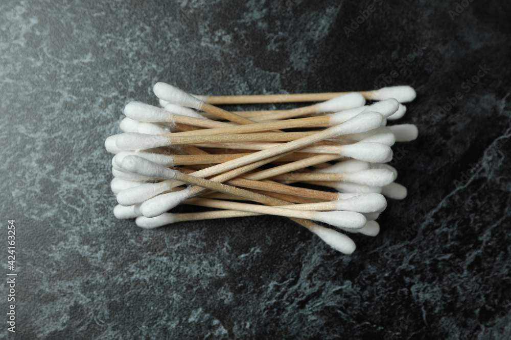 Cotton swabs on black smoky background, close up Cotton swabs on black smoky background, close up