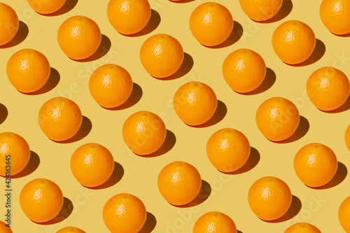 Fototapeta Naklejka Na Ścianę i Meble -  repeated orange on a yellow background