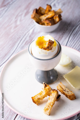 crumpled egg on a stand with croutons