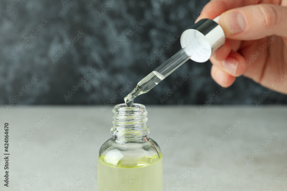 Concept of natural cosmetics with female hand dripping eucalyptus oil Concept of natural cosmetics with female hand dripping eucalyptus oil