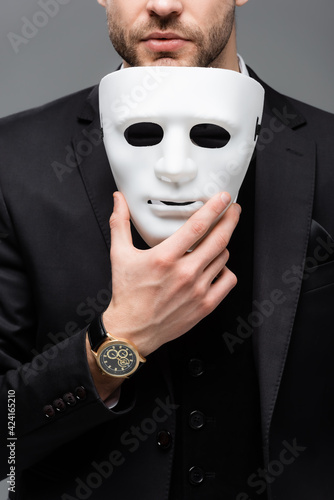 Slika na platnu cropped view of corporate manager holding face mask isolated on grey