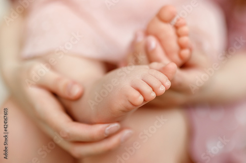 newborn feet in hand