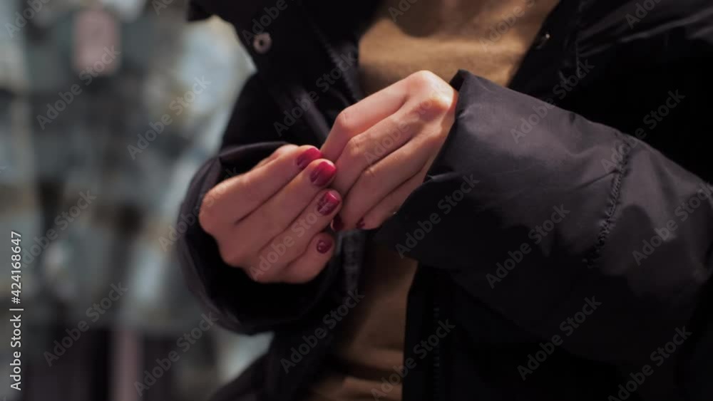 Fashionable lady with red manicure looks at broken nail Fashionable lady with red manicure looks at broken nail