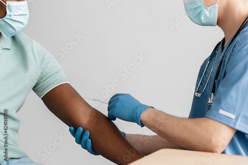 Hand of medical worker injecting coronavirus covid-19 vaccine