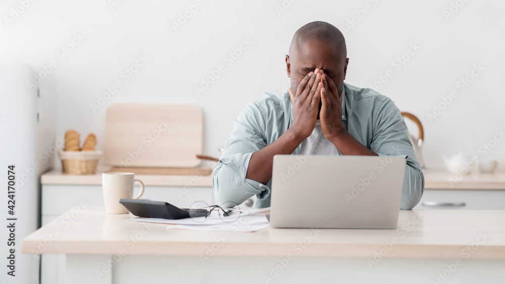 Lack of money concept. Stressed black man checking bills, managing household budget or expenses Lack of money concept. Stressed black man checking bills, managing household budget or expenses