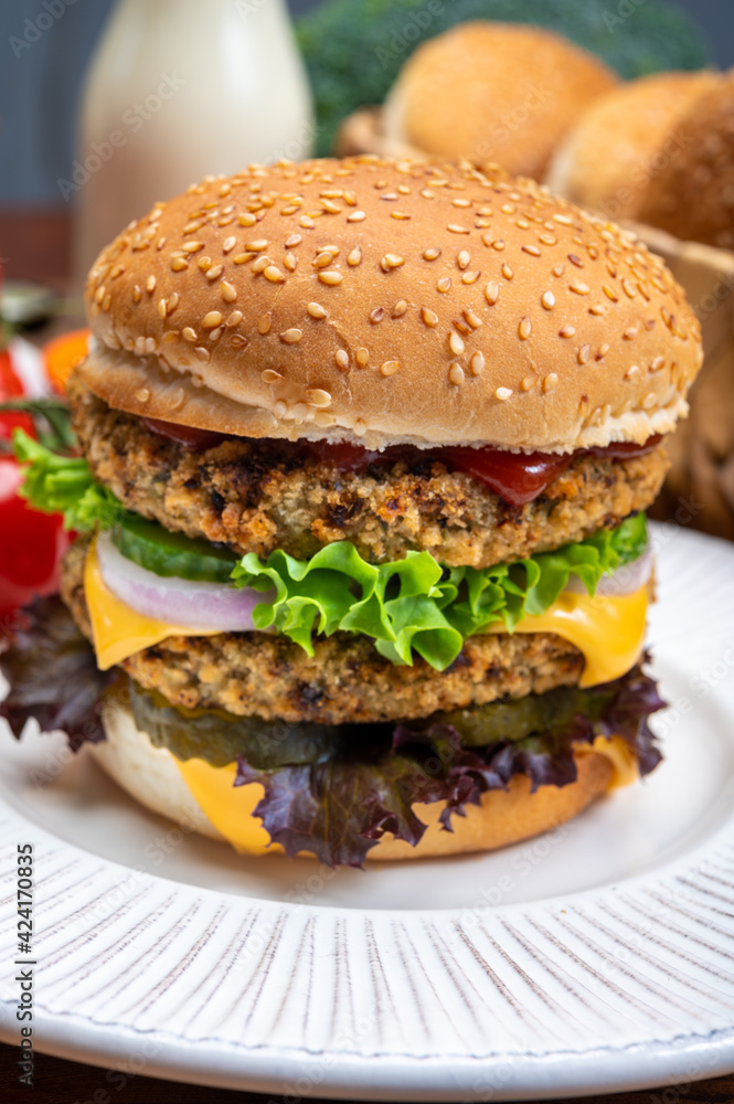 Tasty vegetarian cheeseburgers with round patties or burgers made from grains, vegetables and legumes Tasty vegetarian cheeseburgers with round patties or burgers made from grains, vegetables and legumes