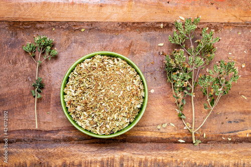 Dried aromatic kitchen herb oregano in green bowl photo