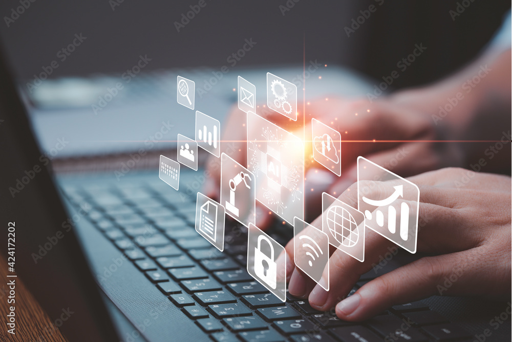 Hand using laptop computer keyboard to control artificial intelligence ...