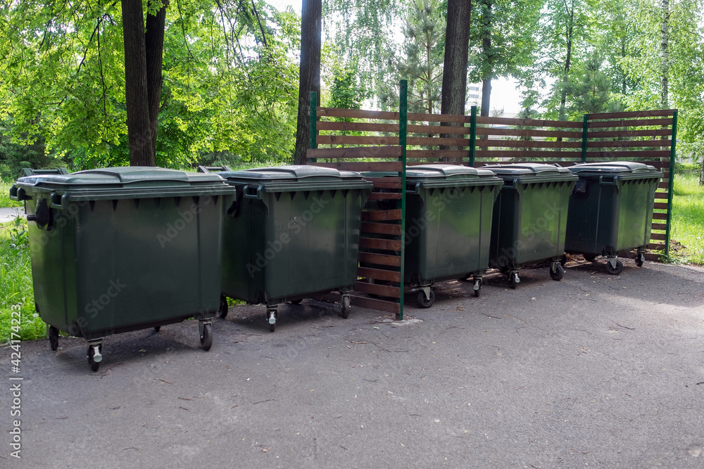 Large garbage containers in the city park. Ecology and cleanliness of urban space. Large garbage containers in the city park. Ecology and cleanliness of urban space.