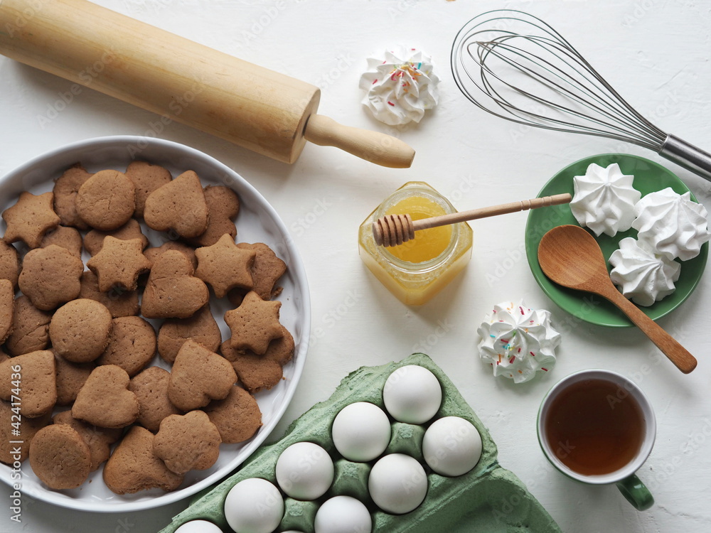 Easter festive background with eggs, cookies, marshmallows, tea with honey. Easter festive background with eggs, cookies, marshmallows, tea with honey.