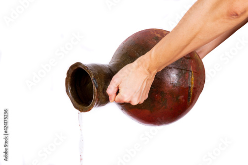 A tilted vessel from which water flows on a white background