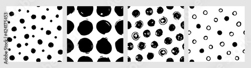 Set of ink dots vector seamless patterns. Hand drawn brush polka dots backdrop. Doodle illustration for wrapping paper and fabric. Contemporary monochrome collection with polka dots patterns